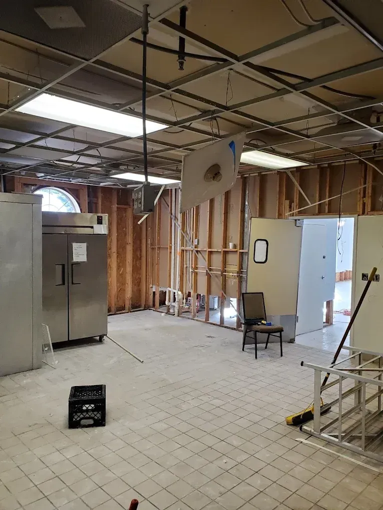 Technician repairing ceiling water damage and drying drywall in an Atlanta home